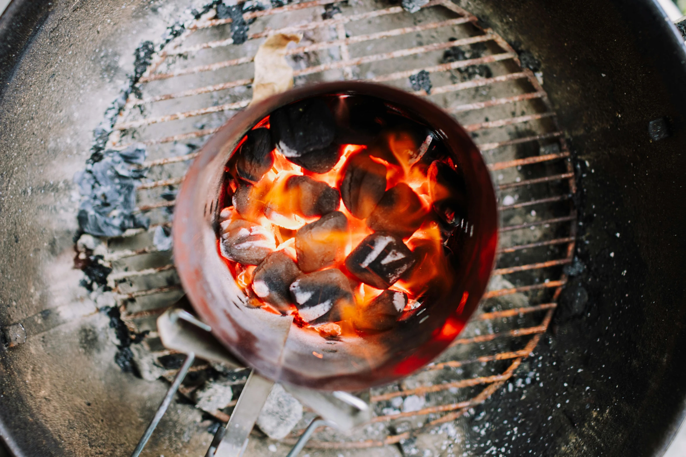 the charcoal on the grill is burnt with bright red sauce