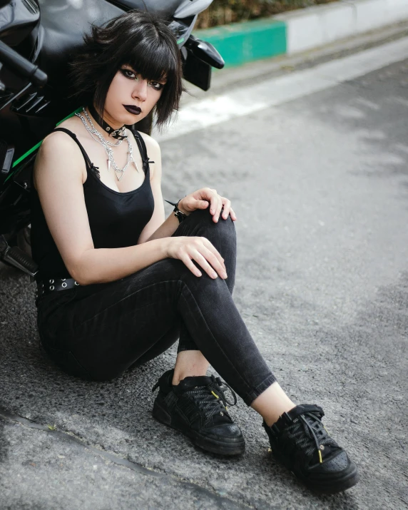 the girl is posing for a po on her motorcycle