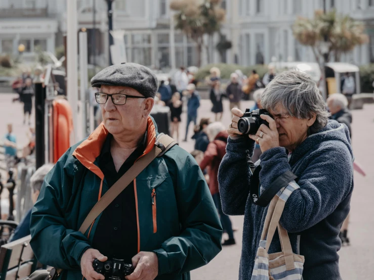 two people talking to each other and one person on a phone