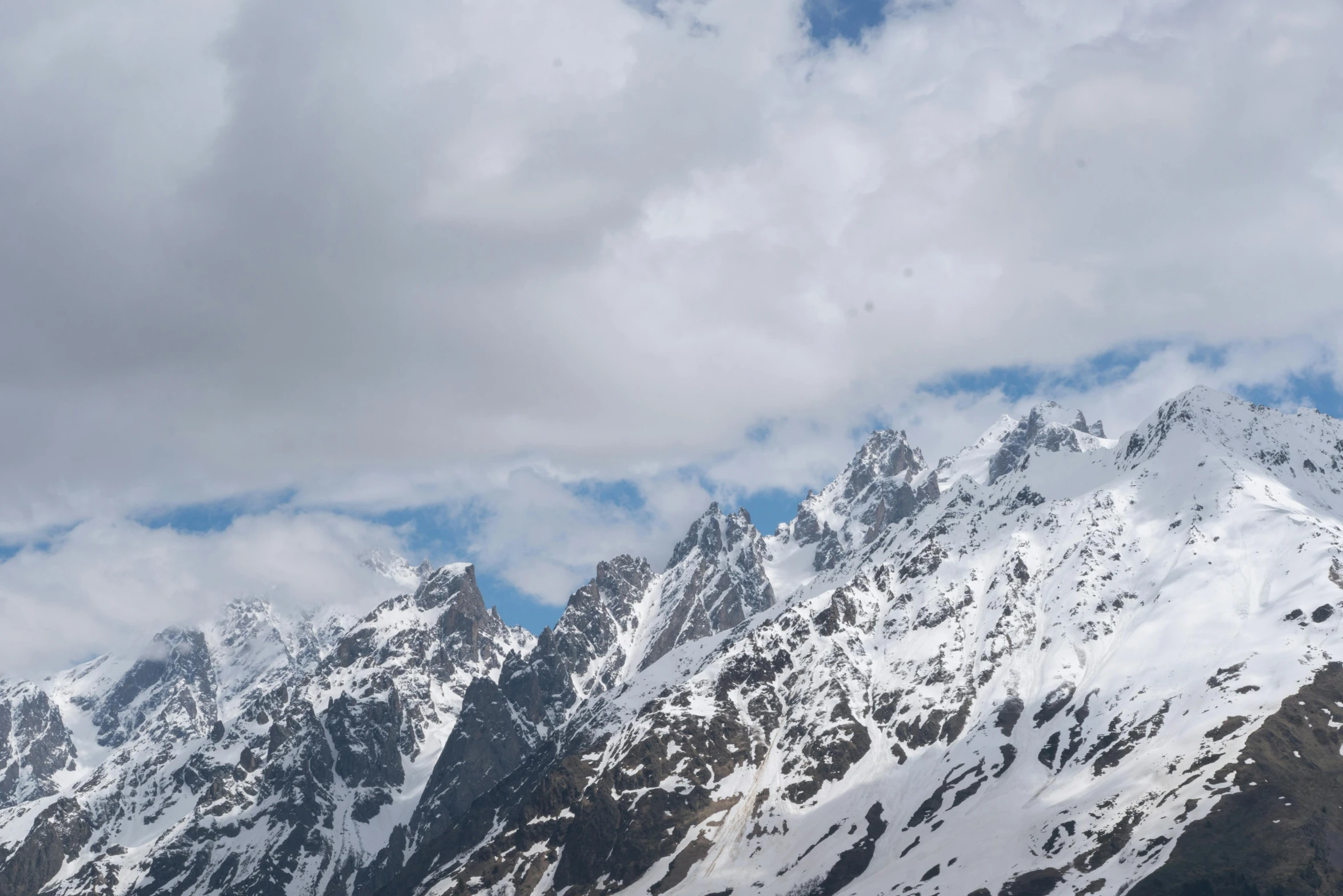 some snow mountains that have snow covered rocks