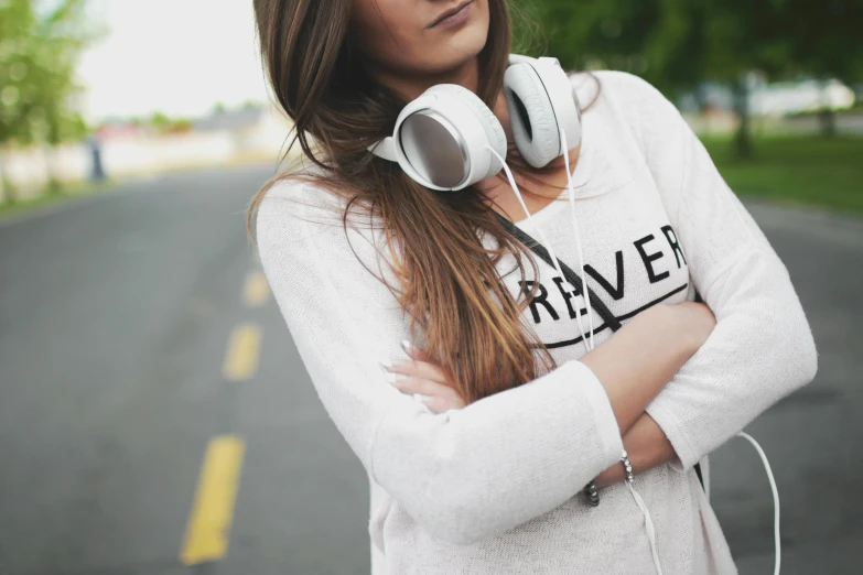 woman standing near street with headphones on