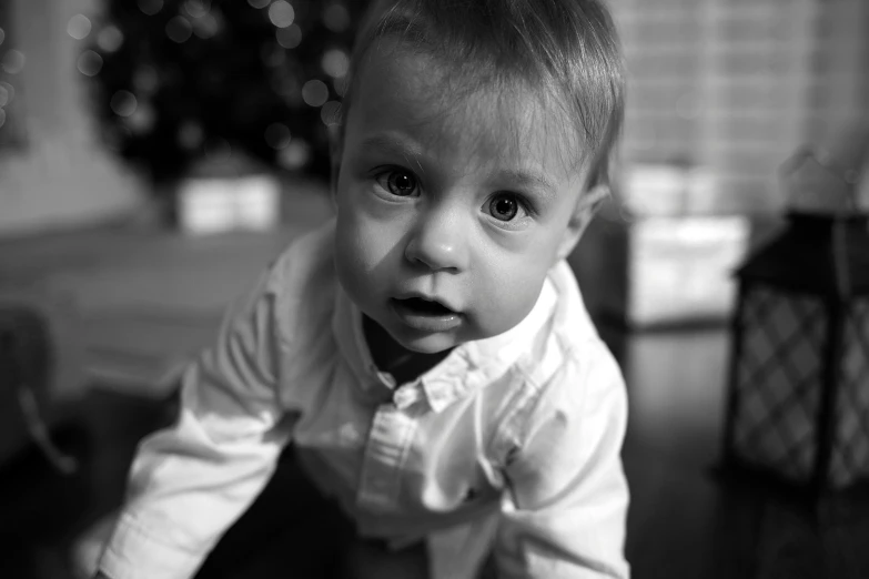 a very cute baby in a shirt with a frown on his face