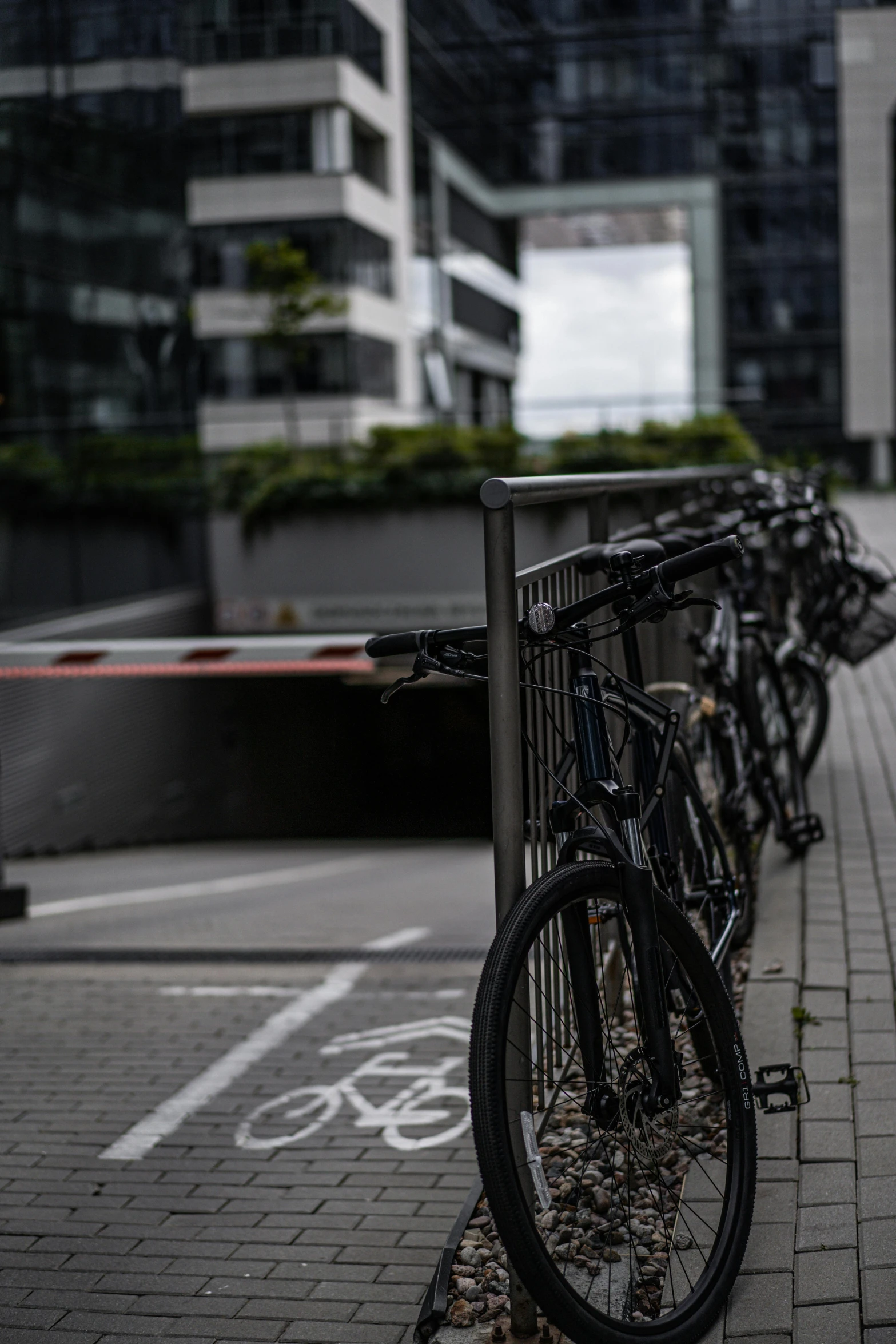 several bikes lined up on a curb in a city