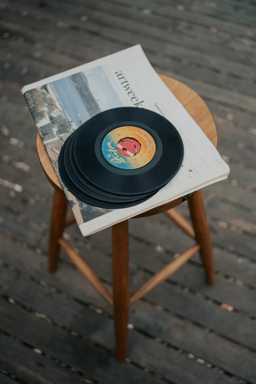 an old record player sitting on top of a magazine