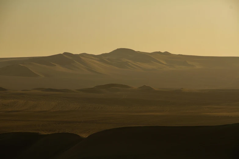 a distant view of an area with high mountains in the distance