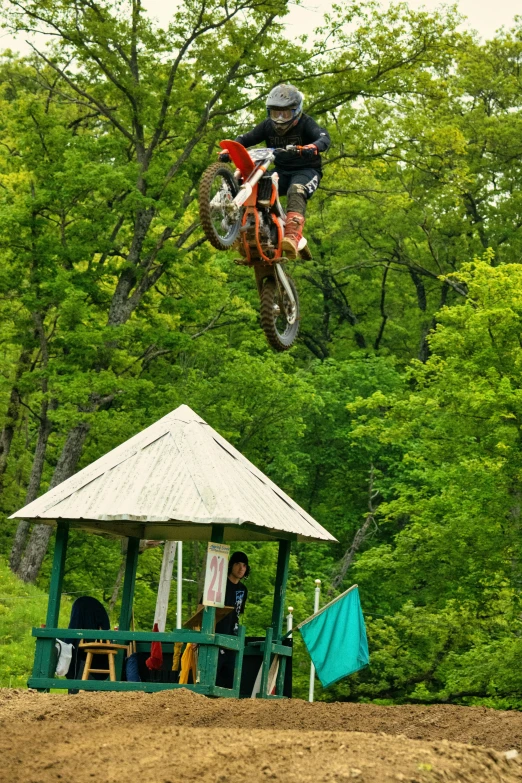 a man in mid air doing a jump on a motor bike