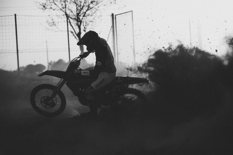 a person riding a dirt bike on top of a grass covered field