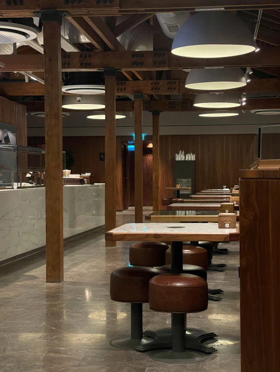 a restaurant with tables and counter top and chairs