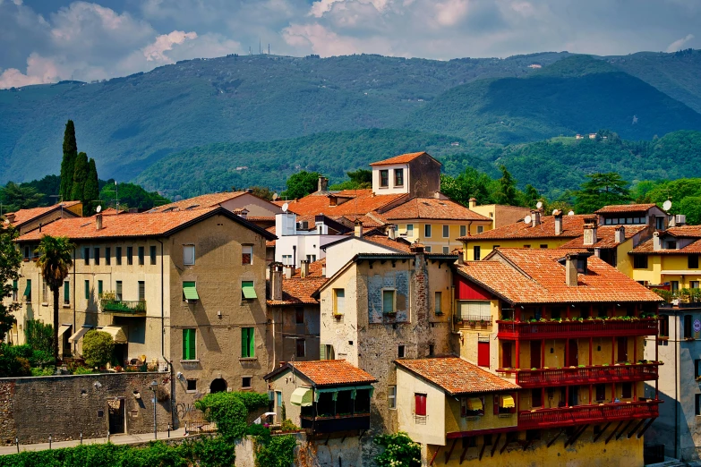 a city with several buildings, and mountains in the background