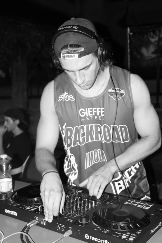 a young man in headphones using a mixing console