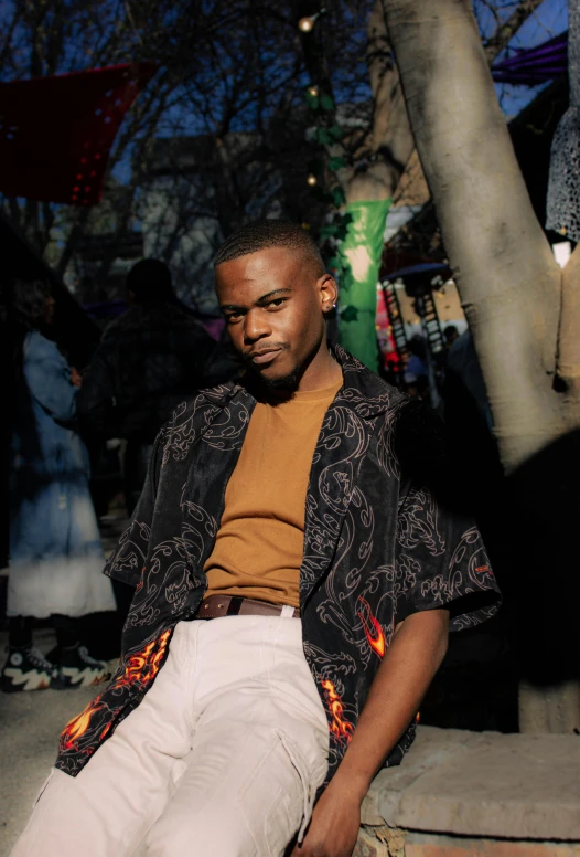 an african american male sitting on a ledge