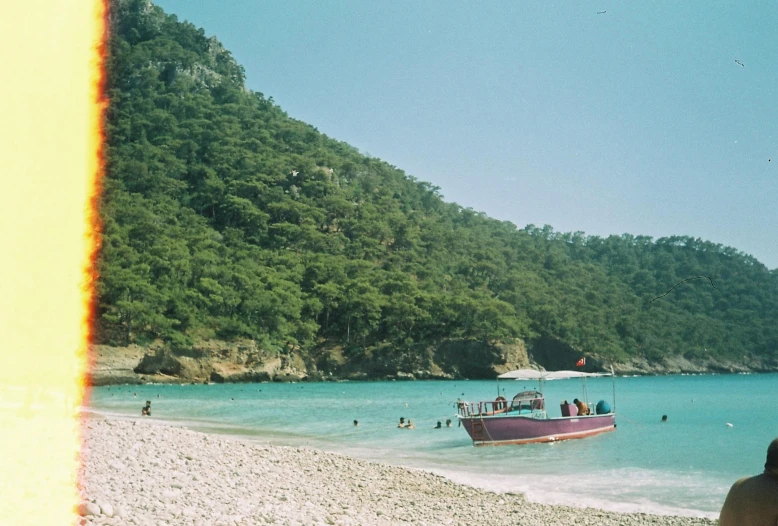 a boat sits at the edge of a beach