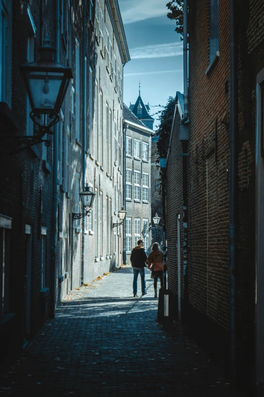 a po of two people walking down a city street