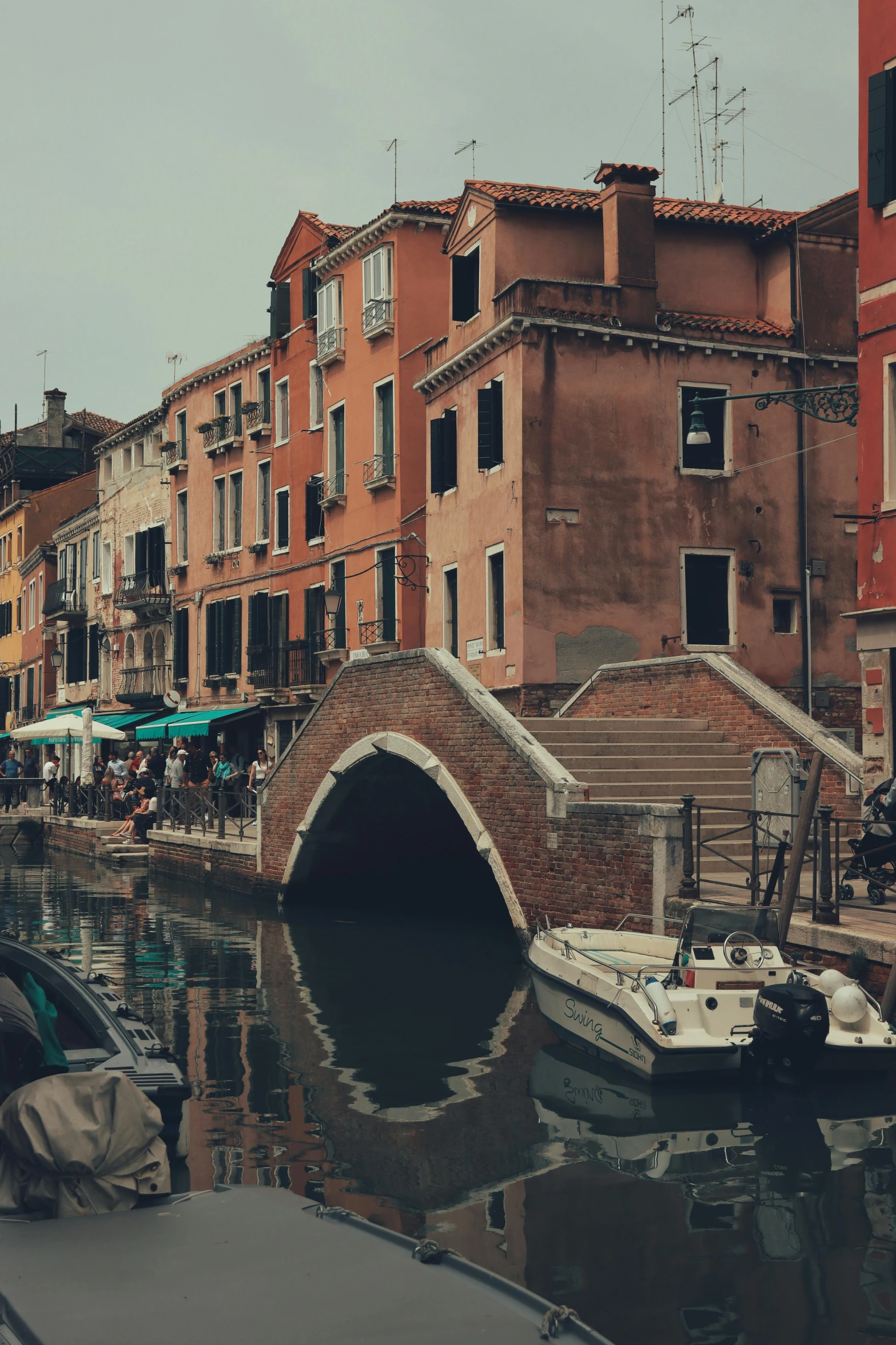 several boats are docked along an old canal