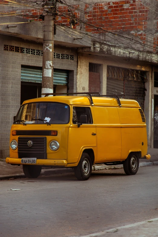 an old yellow bus parked on the side of the street