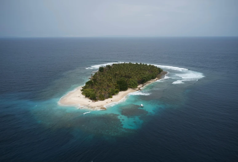 an island in the ocean with one large area that has only two people on it