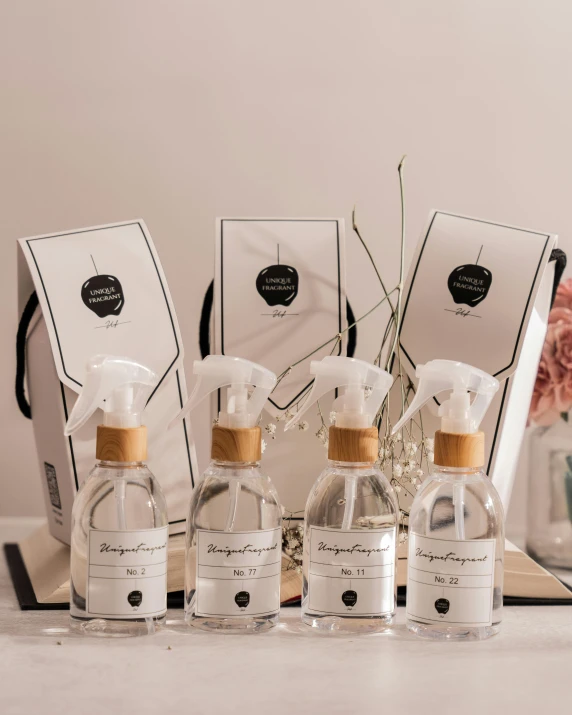 three bottles on a table with a bouquet in front of it