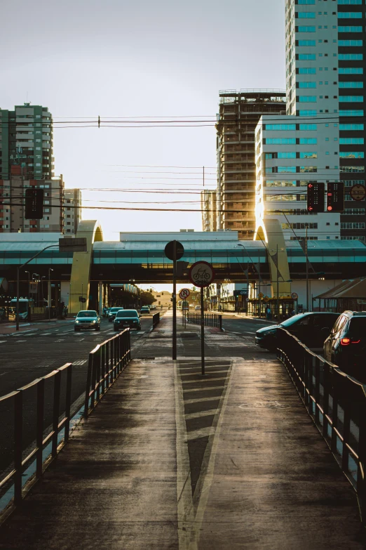 a city street has cars and train tracks