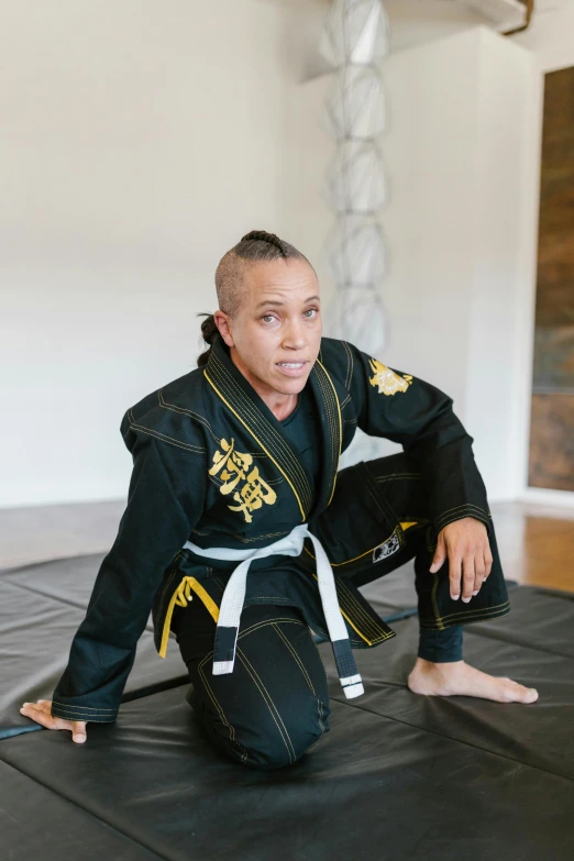 a man wearing black and yellow karate outfits
