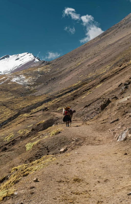 a trail leading to a steep mountain on a clear day