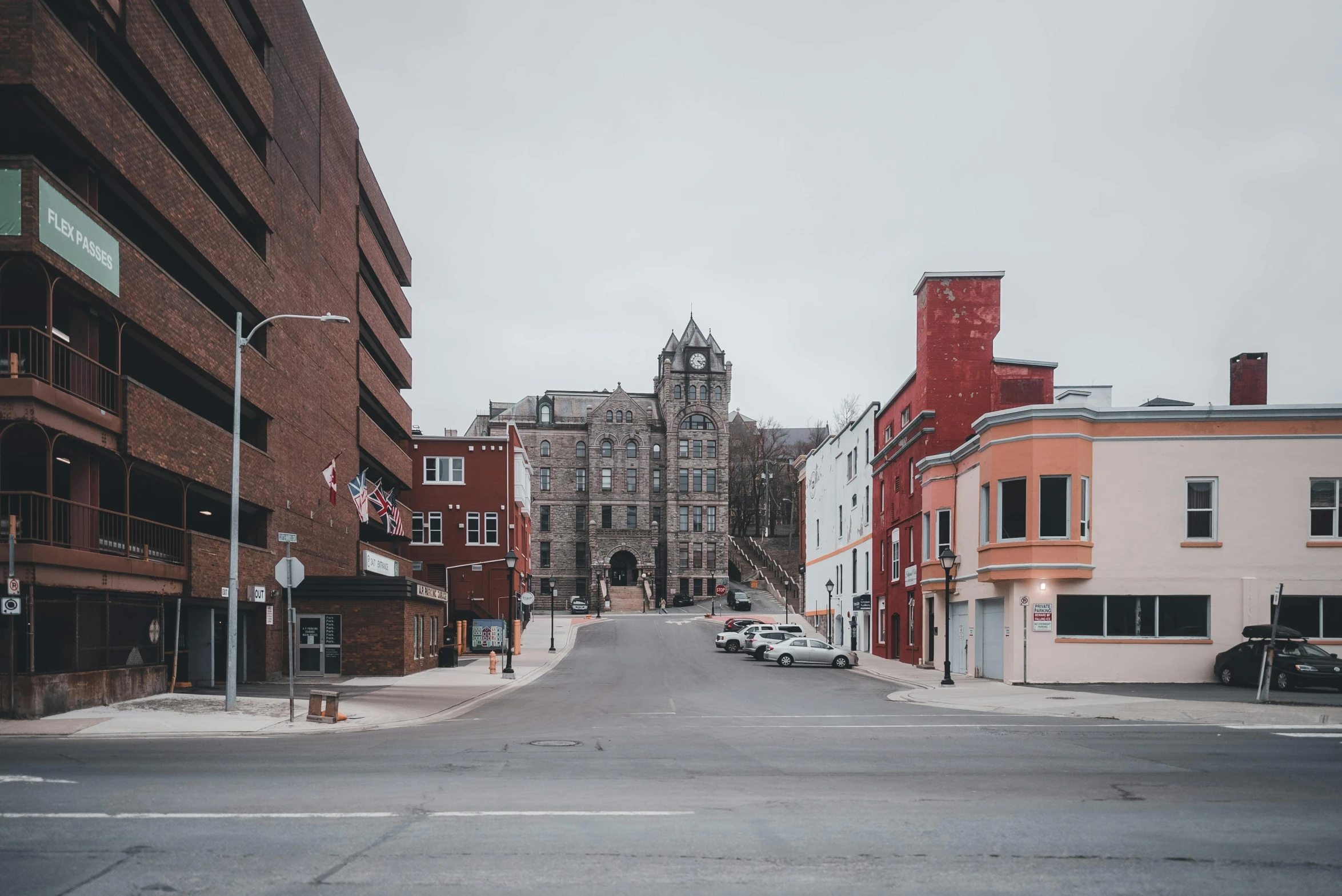 a wide street with a couple of buildings in the background