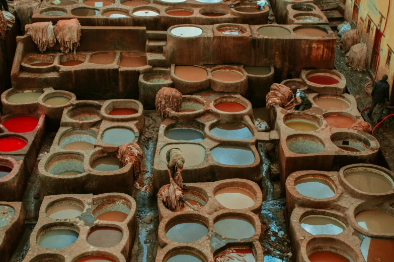a collection of pottery pots sitting in front of a building