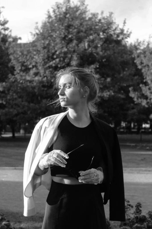 black and white po of a woman standing in the grass