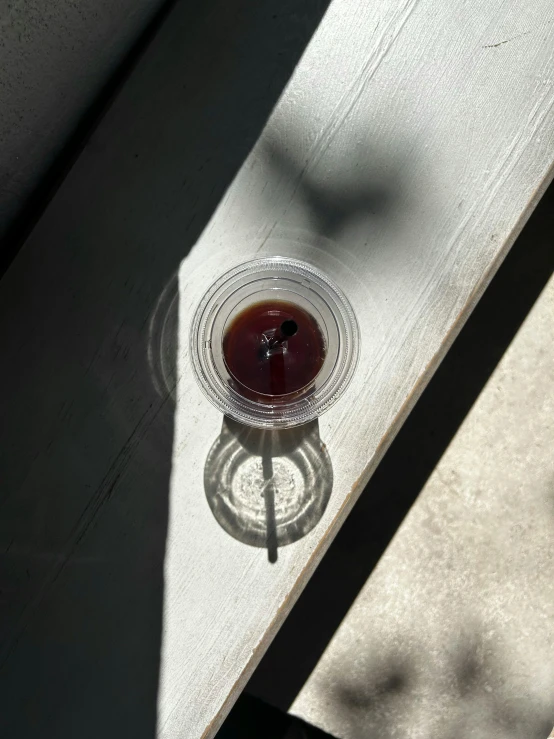 a glass cup with liquid inside on the table