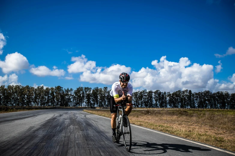 a man on a bike rides down the road