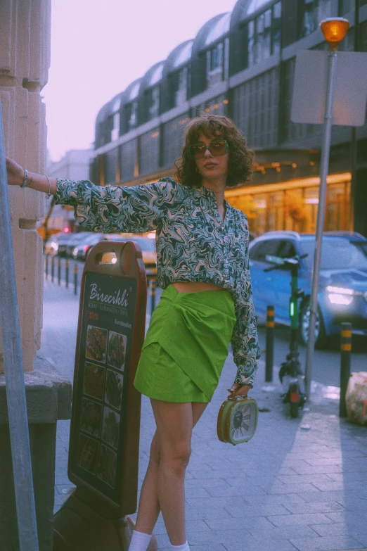 a person with green skirts walking down the street