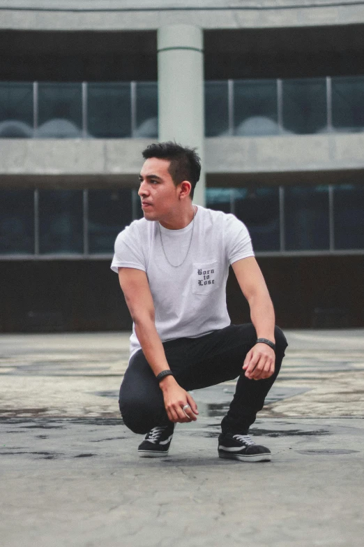 a man crouched down in the ground outside