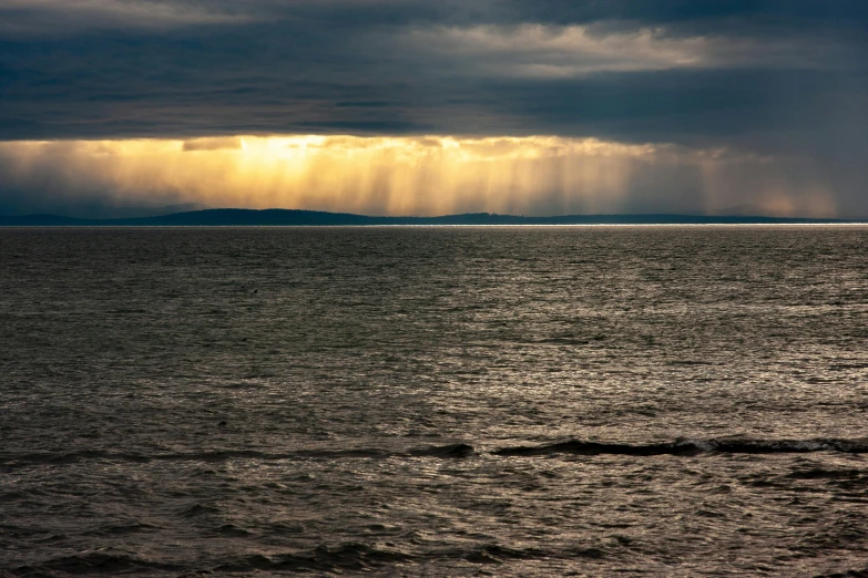 the sunbeams above the water in this picture