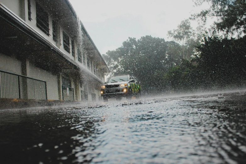 a truck is driving down the road in the rain