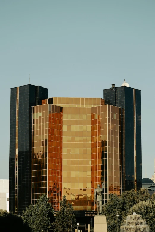 a statue is near a tall building with two windows