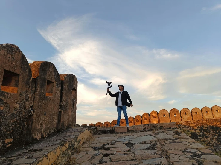 a man stands on a rock with his remote control