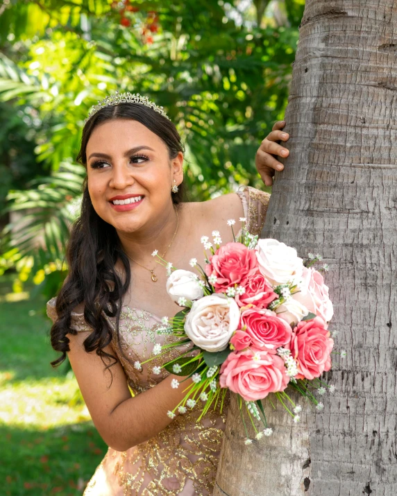 a woman with flower bouquet in hand next to a tree