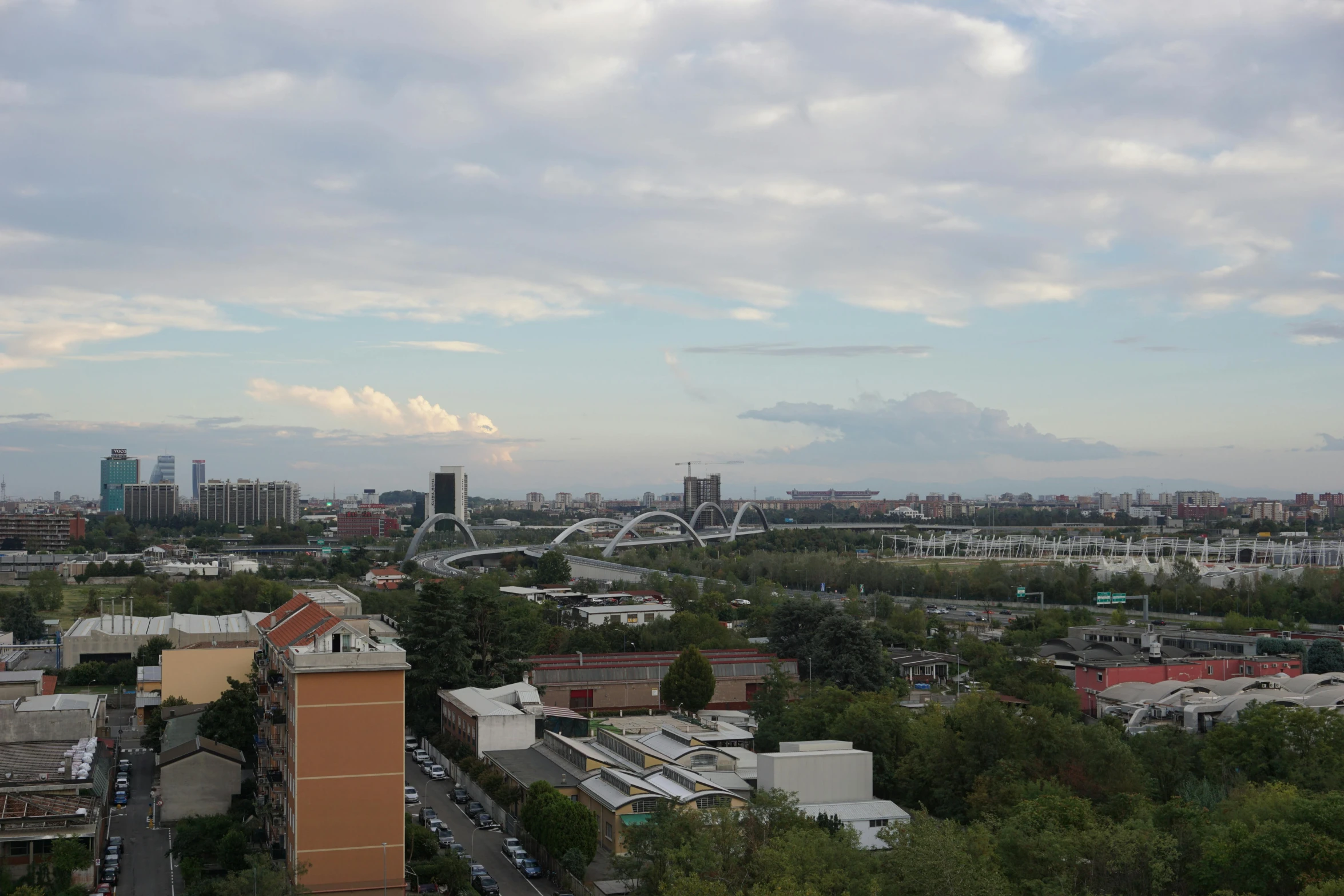 a skyline shows many city buildings, and tall trees