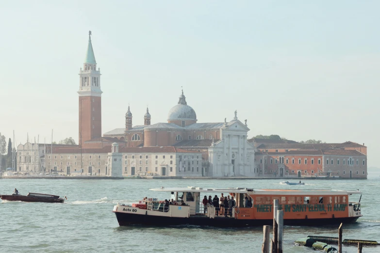 a boat and a boat are next to the buildings on the water