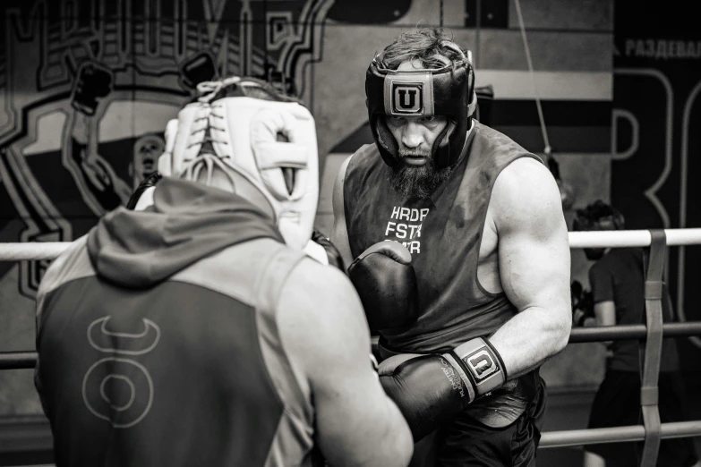 a male wrestler wears a protective helmet and a mask