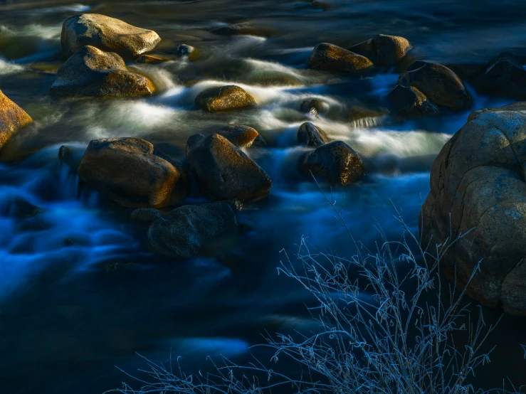 some rocks and water at night time