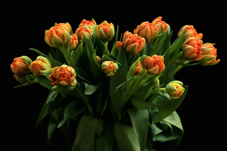 a large vase filled with orange flowers on top of a table