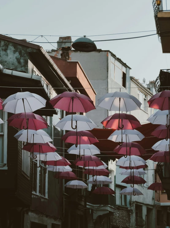 large umbrellas are hanging on the side of the street