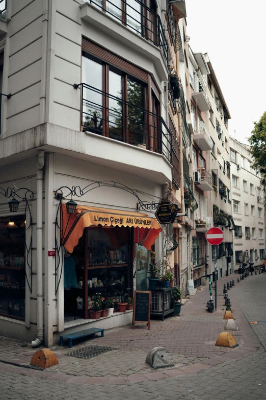 a store front with red and white awnings