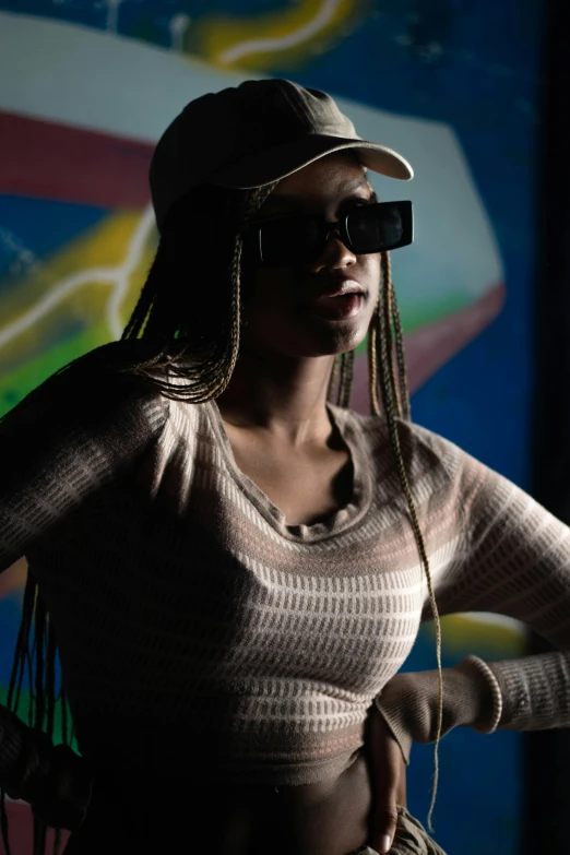 a woman wearing sunglasses and a hat with the light from the camera