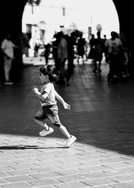 black and white image of little girl in a city