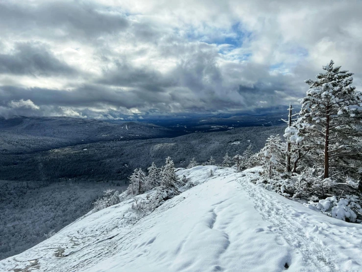 a scenic ski slope on top of a snow covered hill