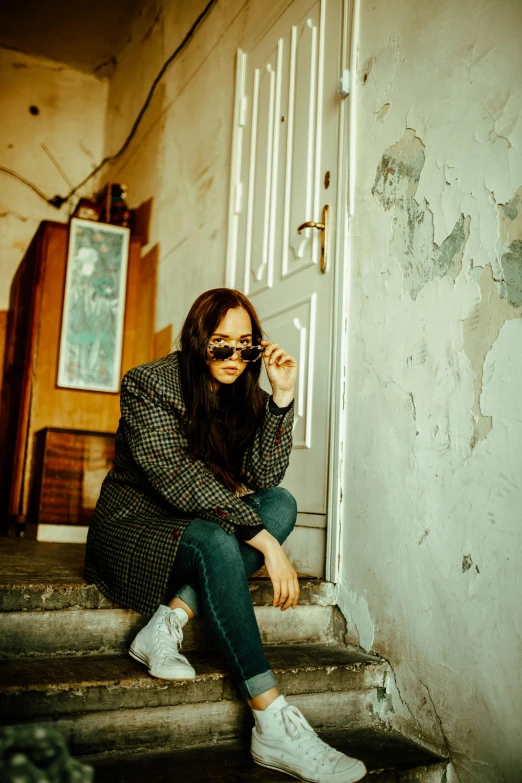 a person sitting on stairs with their hands resting on their head