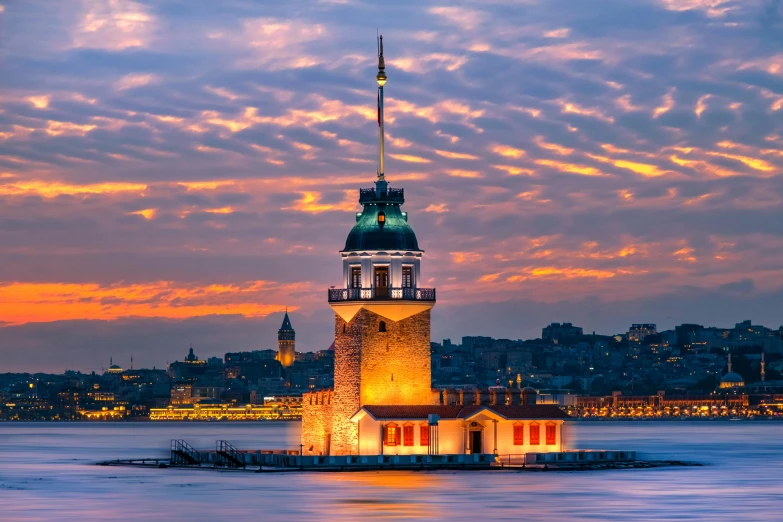 the clock tower is illuminated in lights of sunset