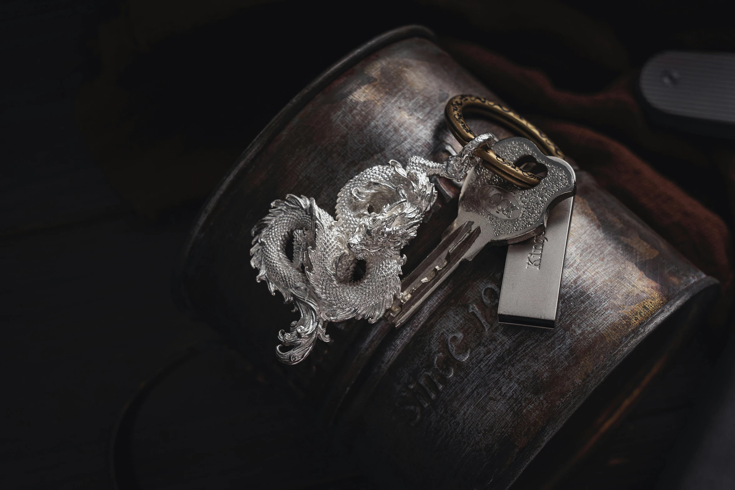 a close up of a leather luggage with two key chains