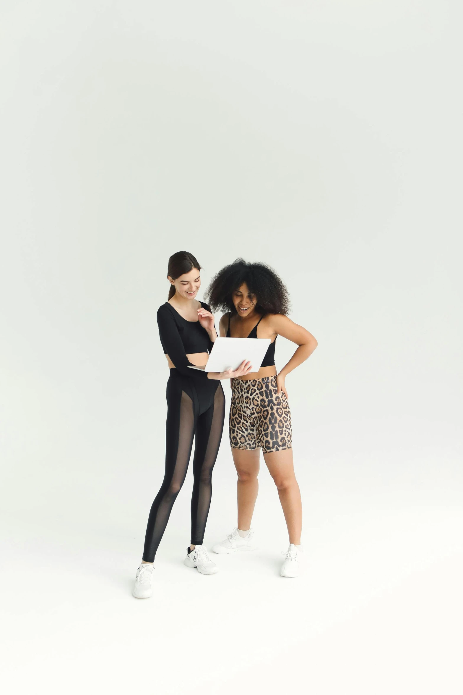 two young women with leggings and black leotards